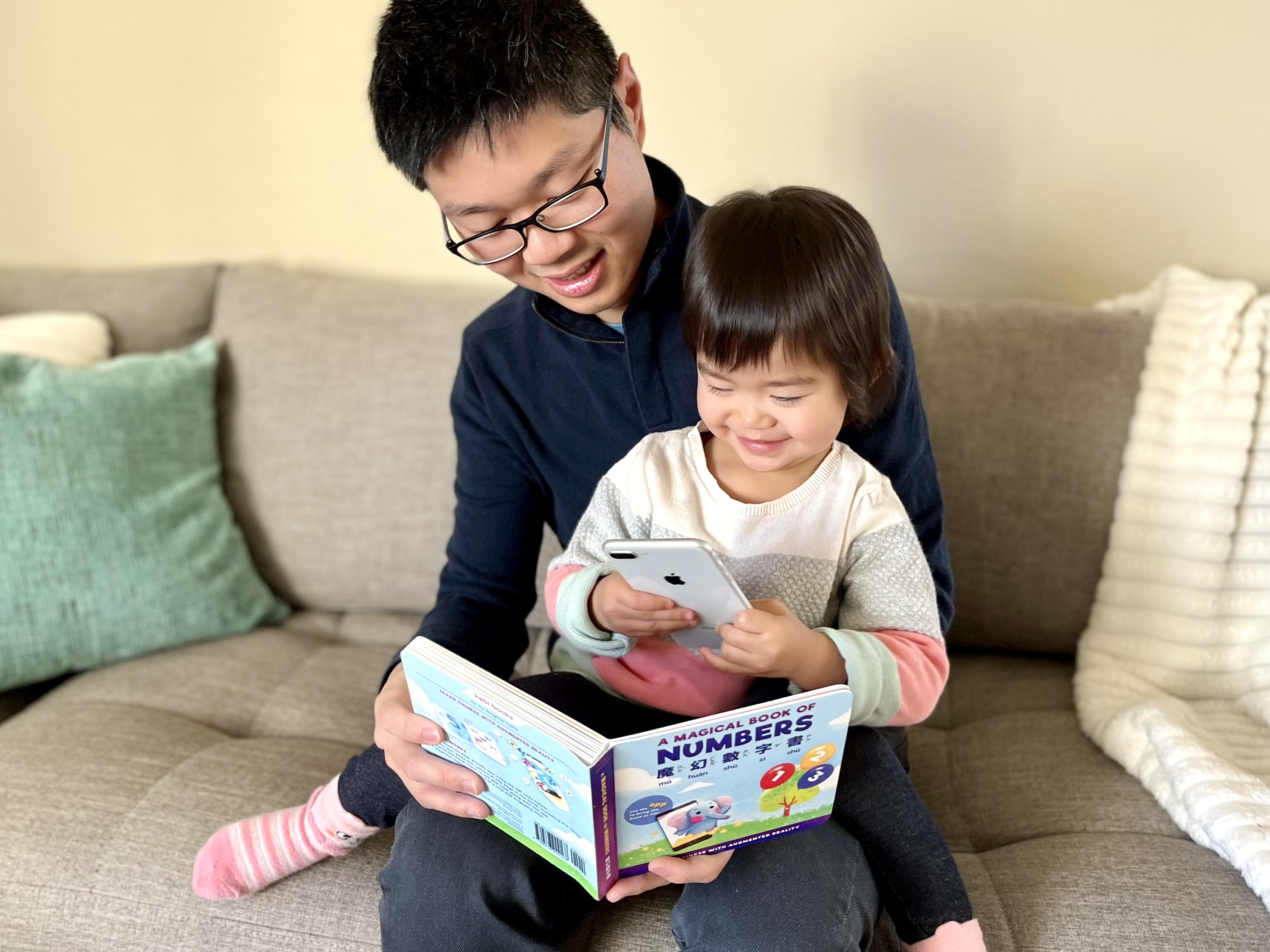 Nathan reading A Magical Book of Numbers with his daughter